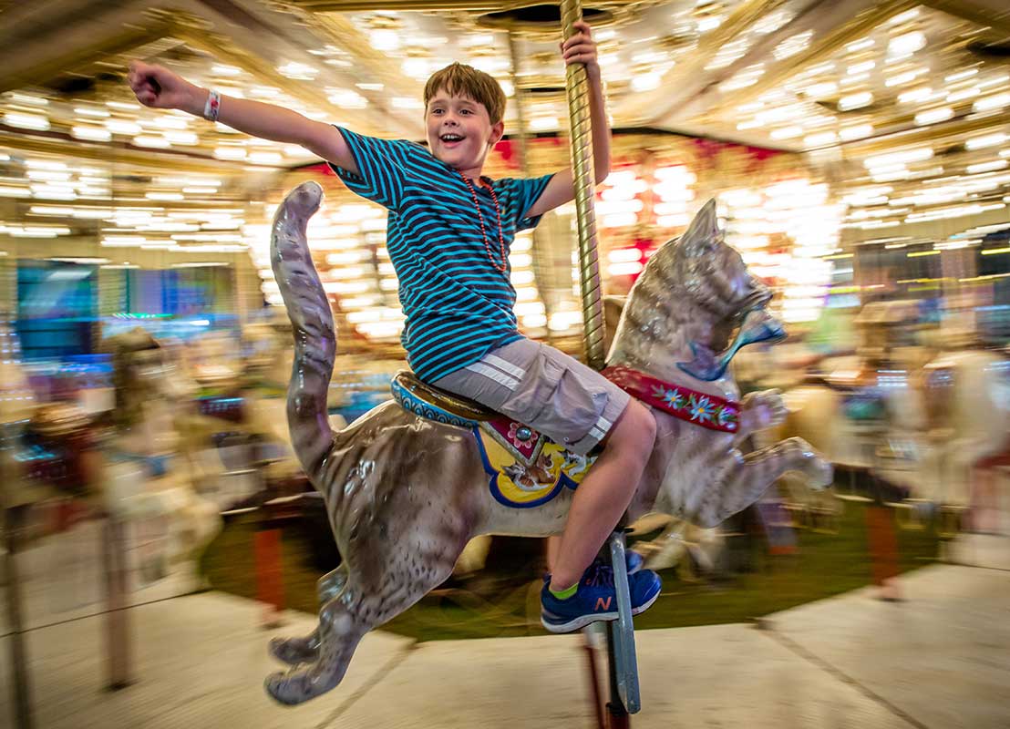 boy on carousel Franklin County Fair