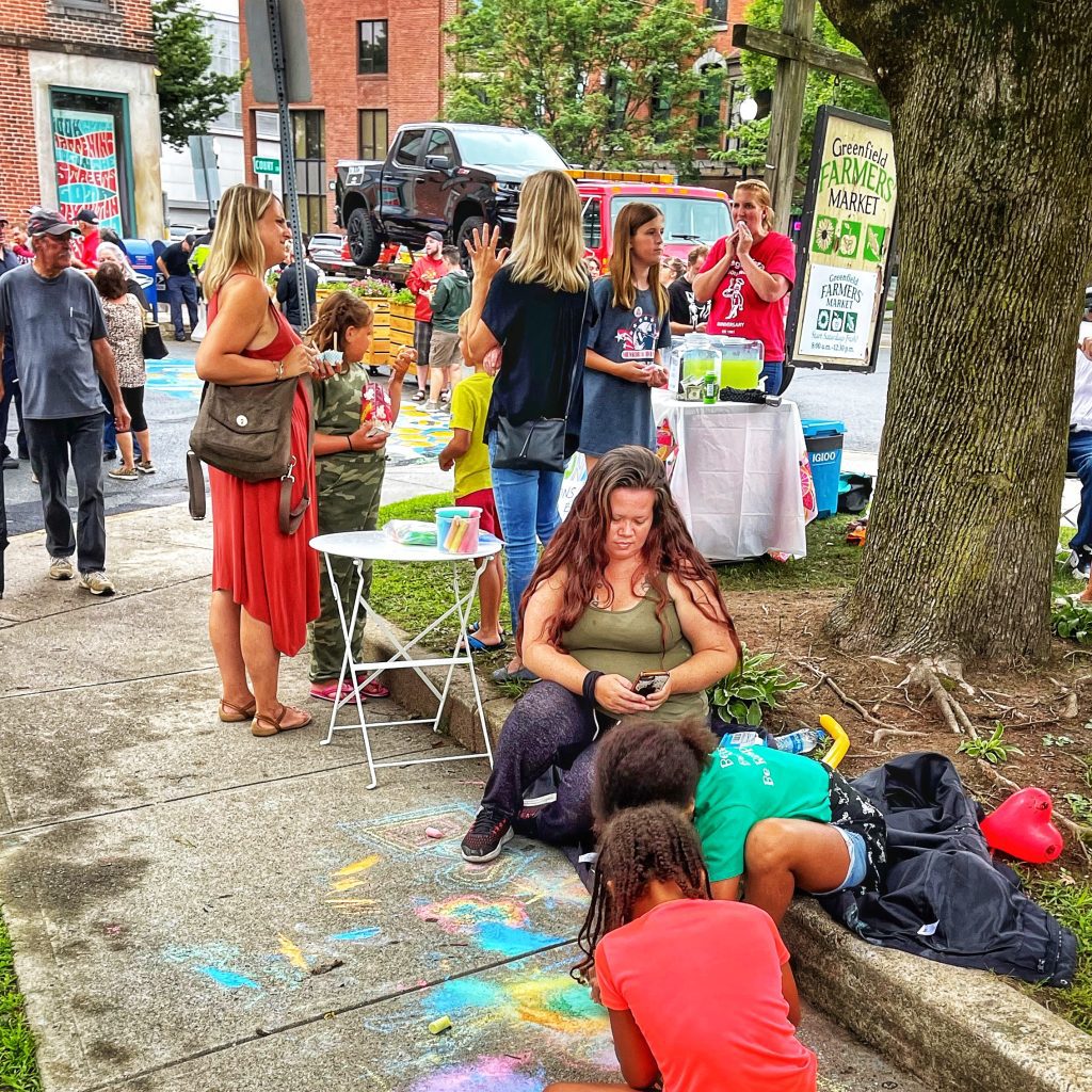 kids doing chalk drawing at Court Square